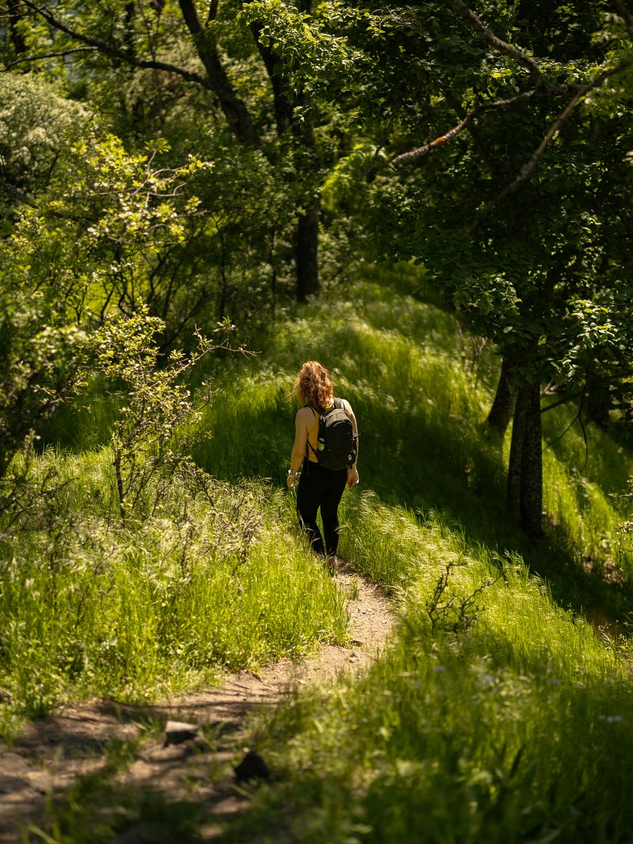 Person hiking, gardening, or traveling — living fully
